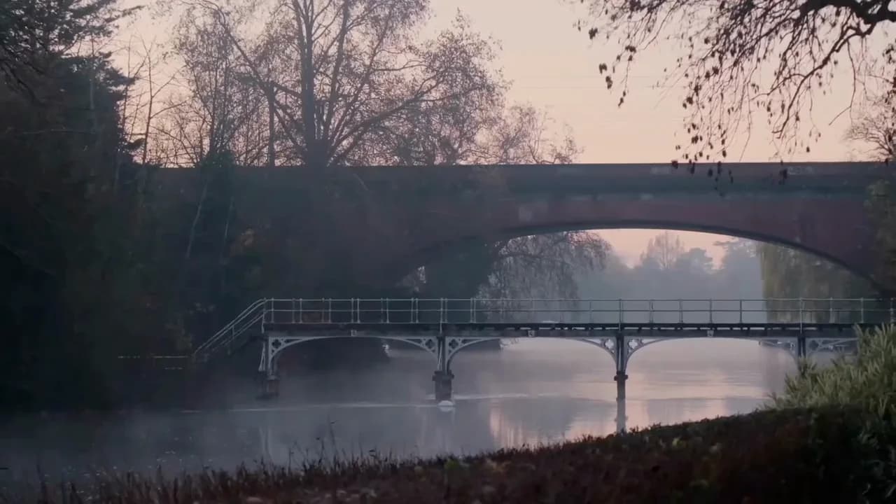 A stone bridge over the Thames in morning mist