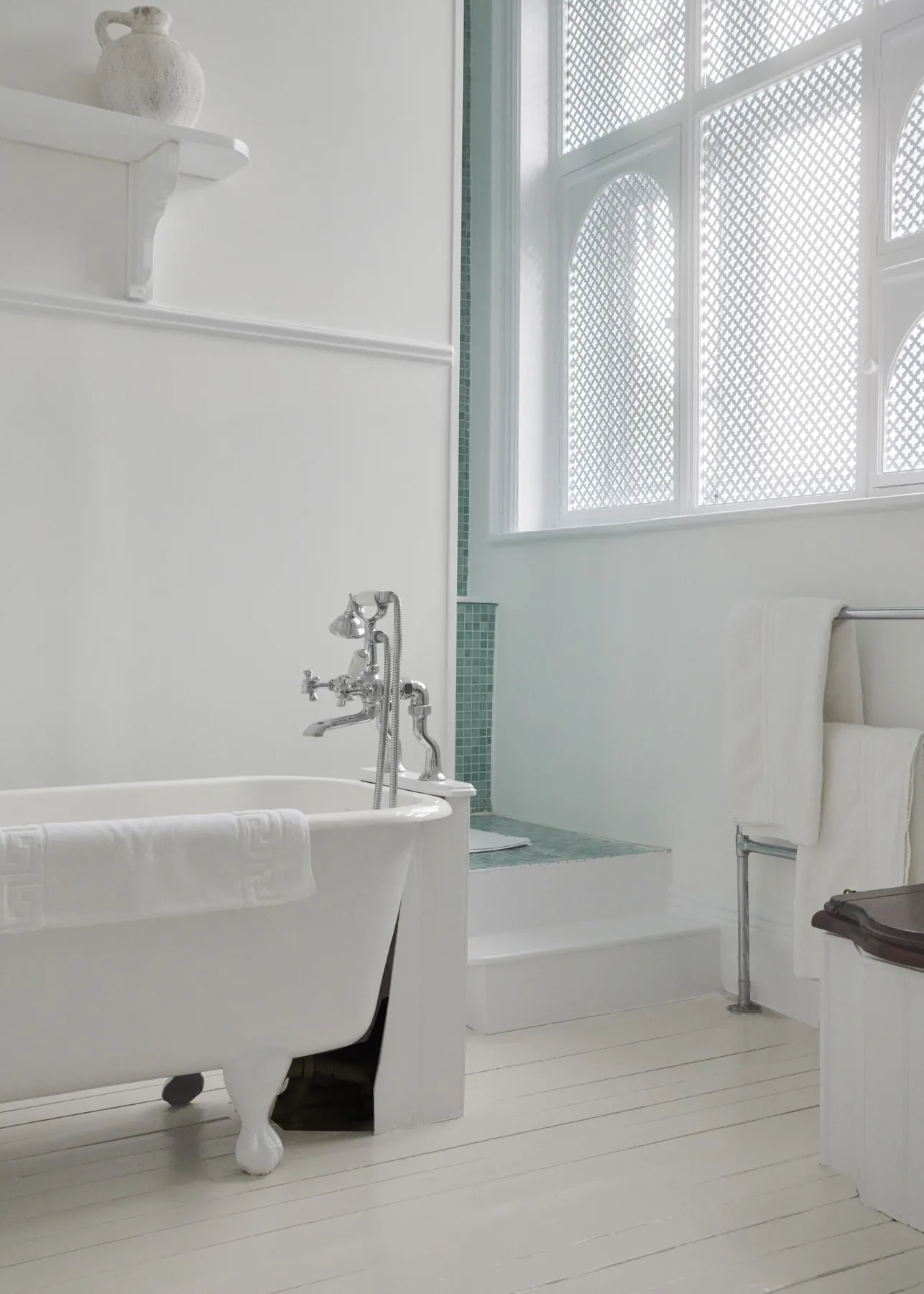 The Being Julia bathroom, with a mint pedestal basin and a roll-top bath