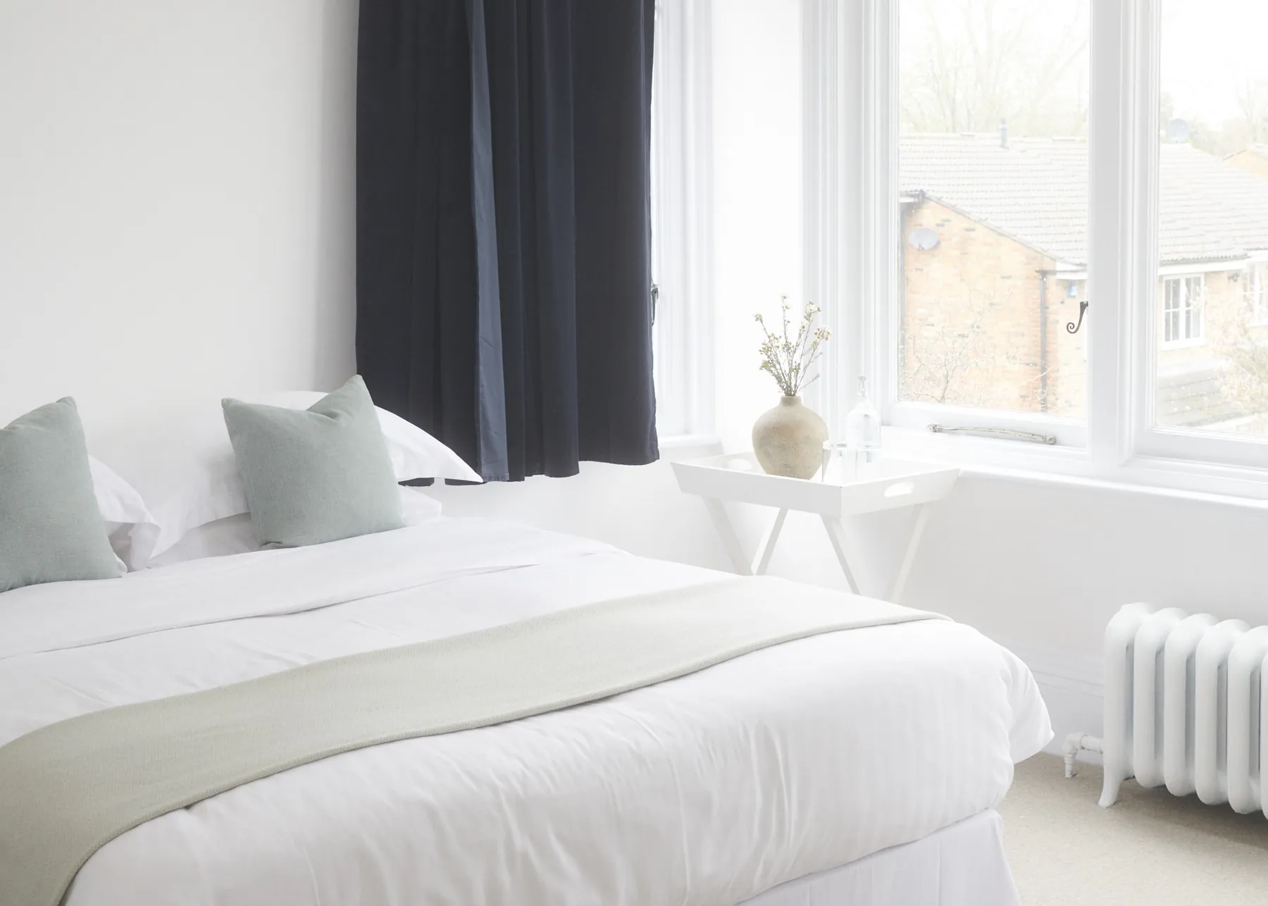 Sage cushions on the bed in Being Julia
