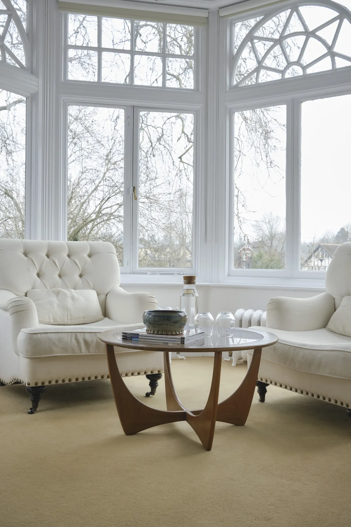 Armchairs and a round table in the turret bay of Brunel's Arch