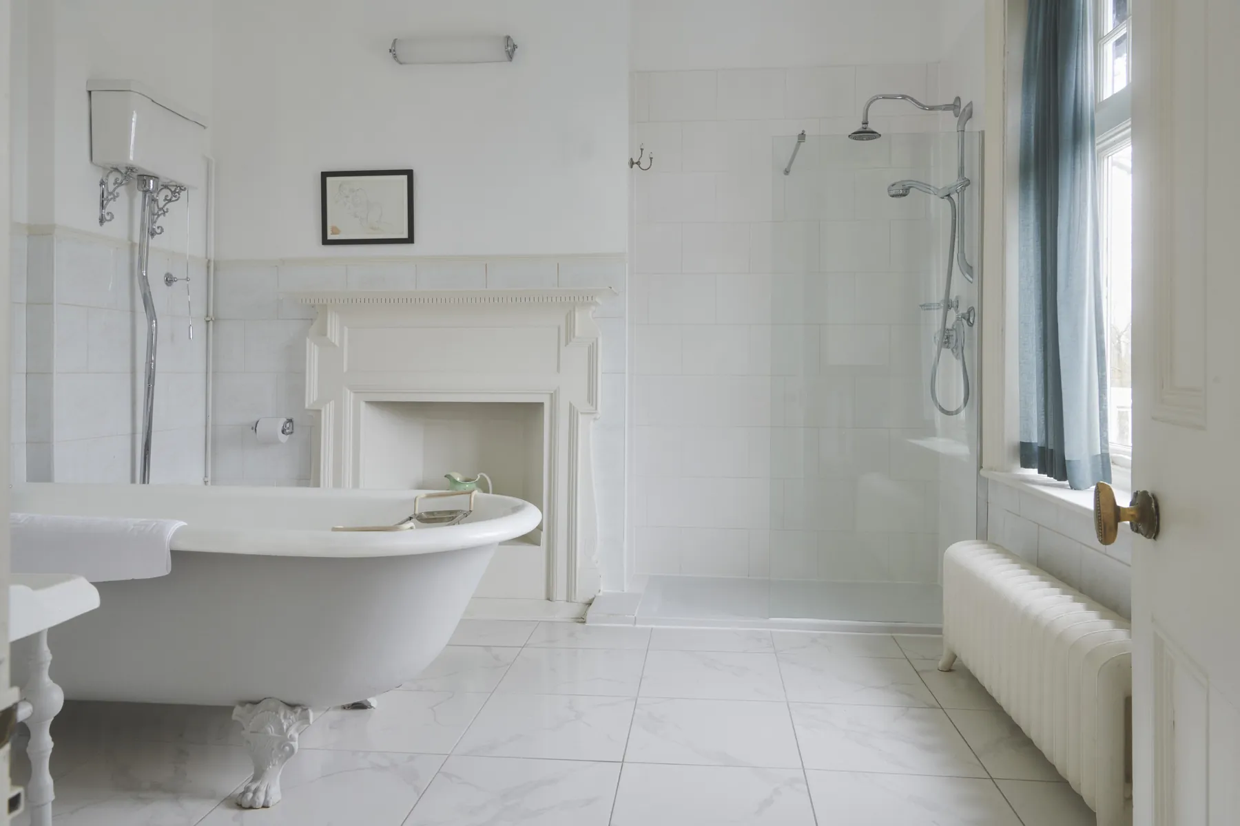 The Guards Club bathroom, with a roll-top bath and a walk-in shower