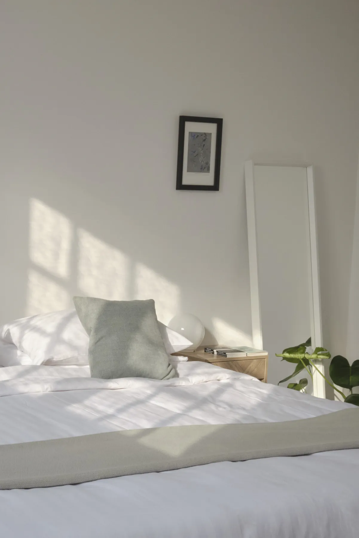 Sunlight across the bed and the tall mirror in Kashgar