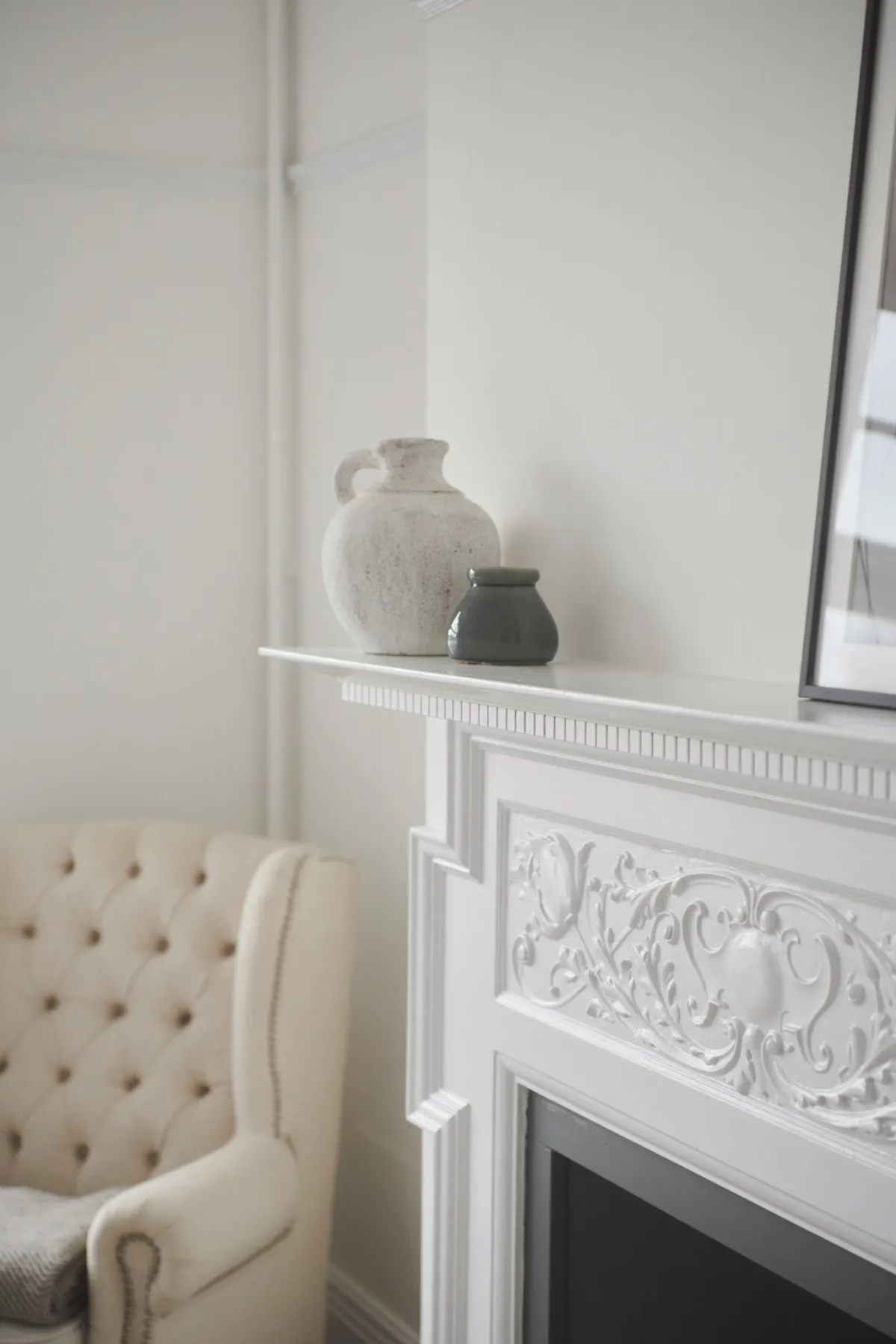 The carved mantelpiece and an armchair in Nympheas