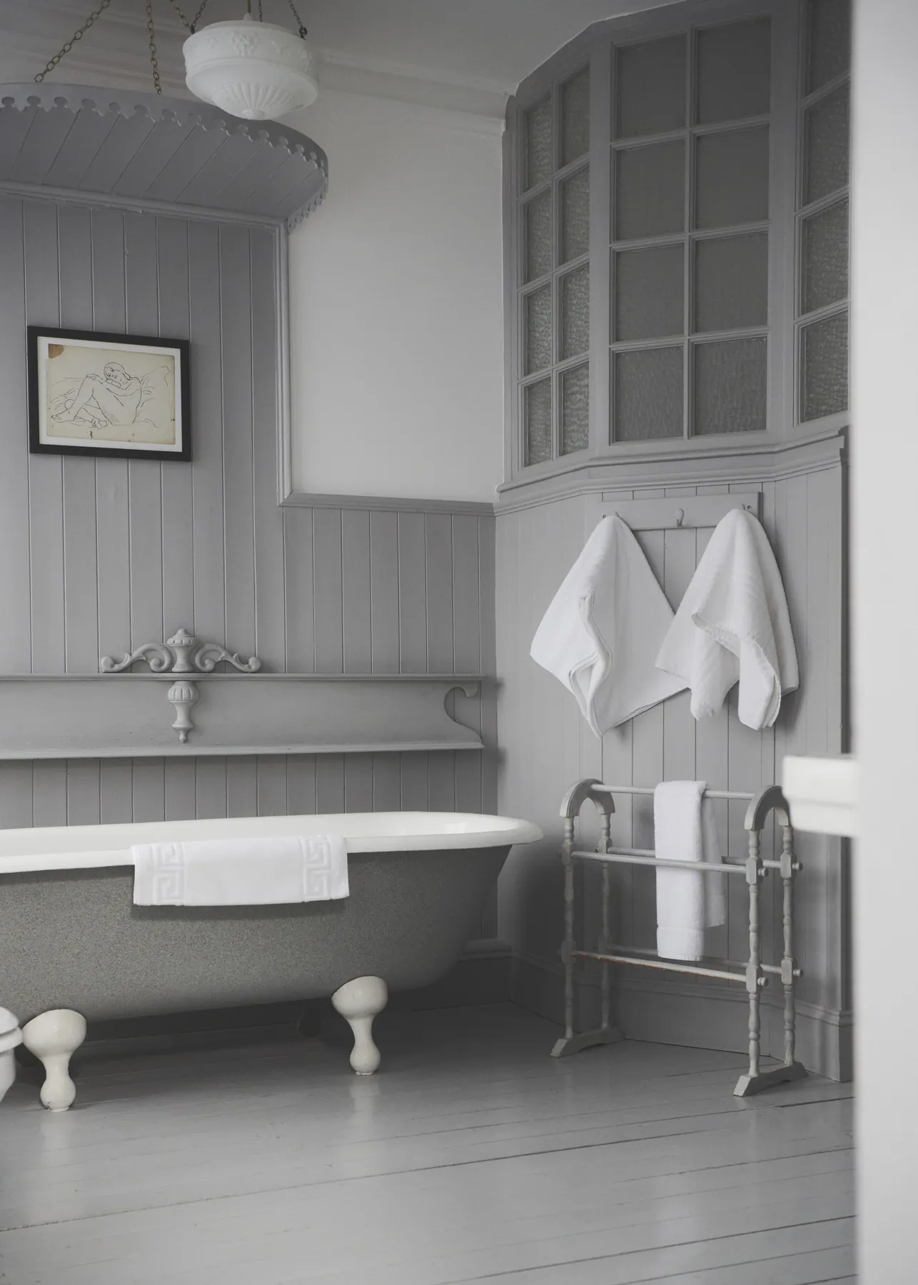 The Oldfield bathroom, with a roll-top bath and panelled walls