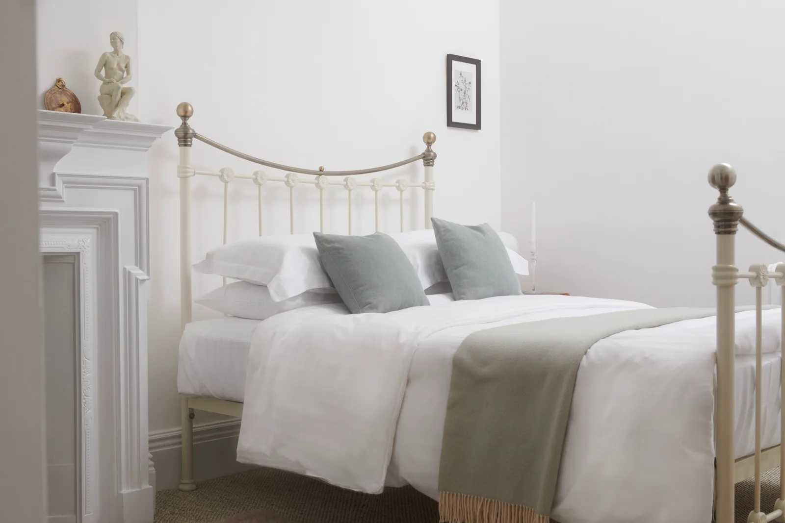 A Tiny Room with a brass bed frame and ornamental fireplace