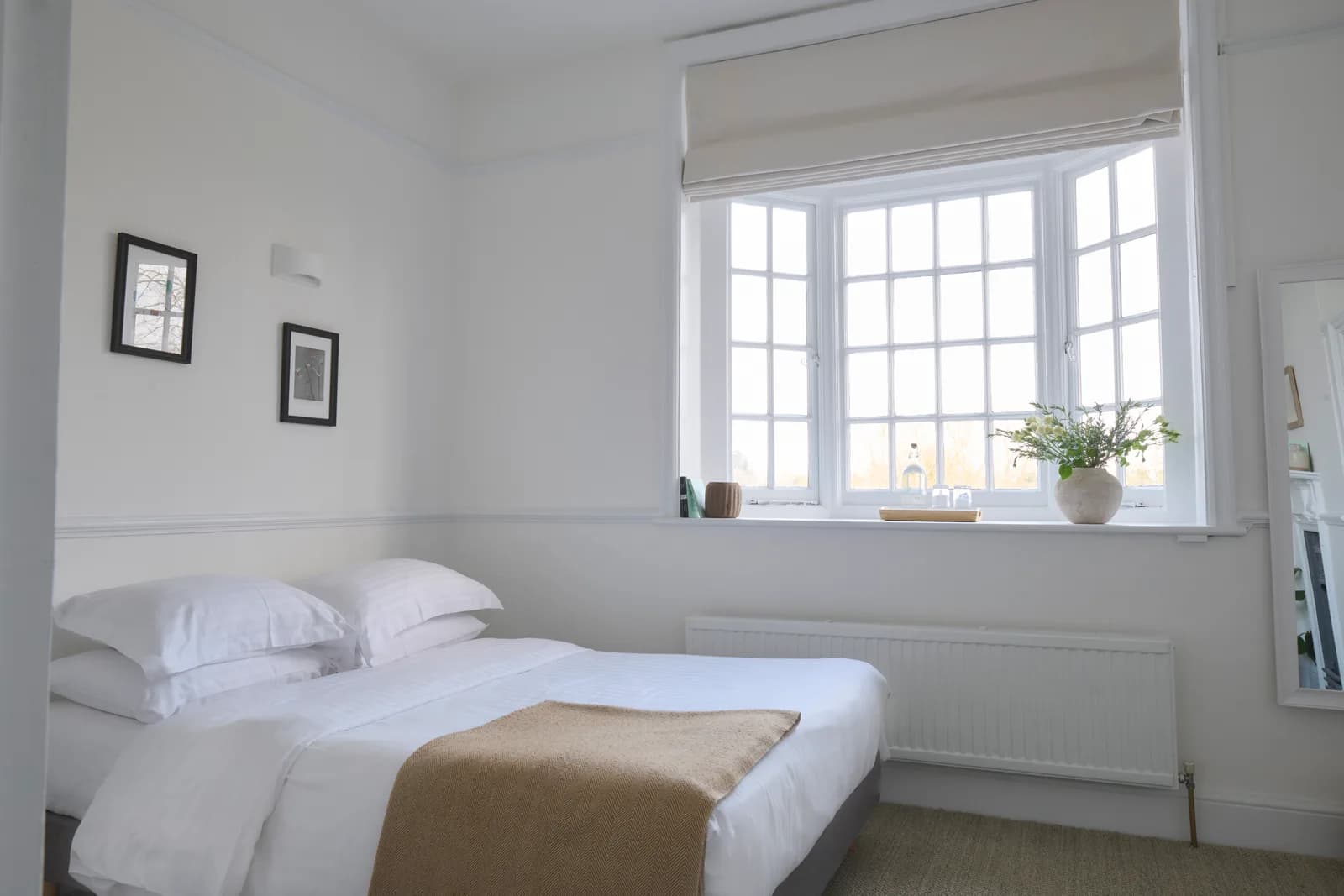 A Tiny Room with a double bed, soft linen and a wide bay window